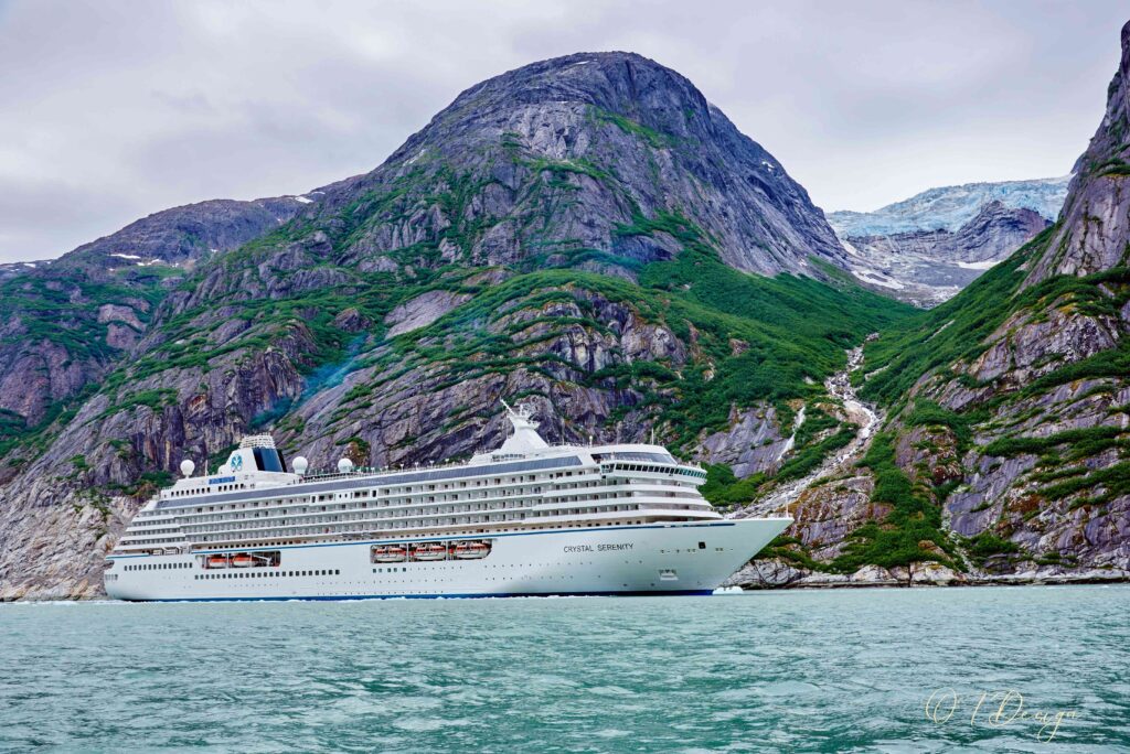 Crystal Serenity cruise ship sailing through ice in the bay of Endicott Arm, Alaska, USA