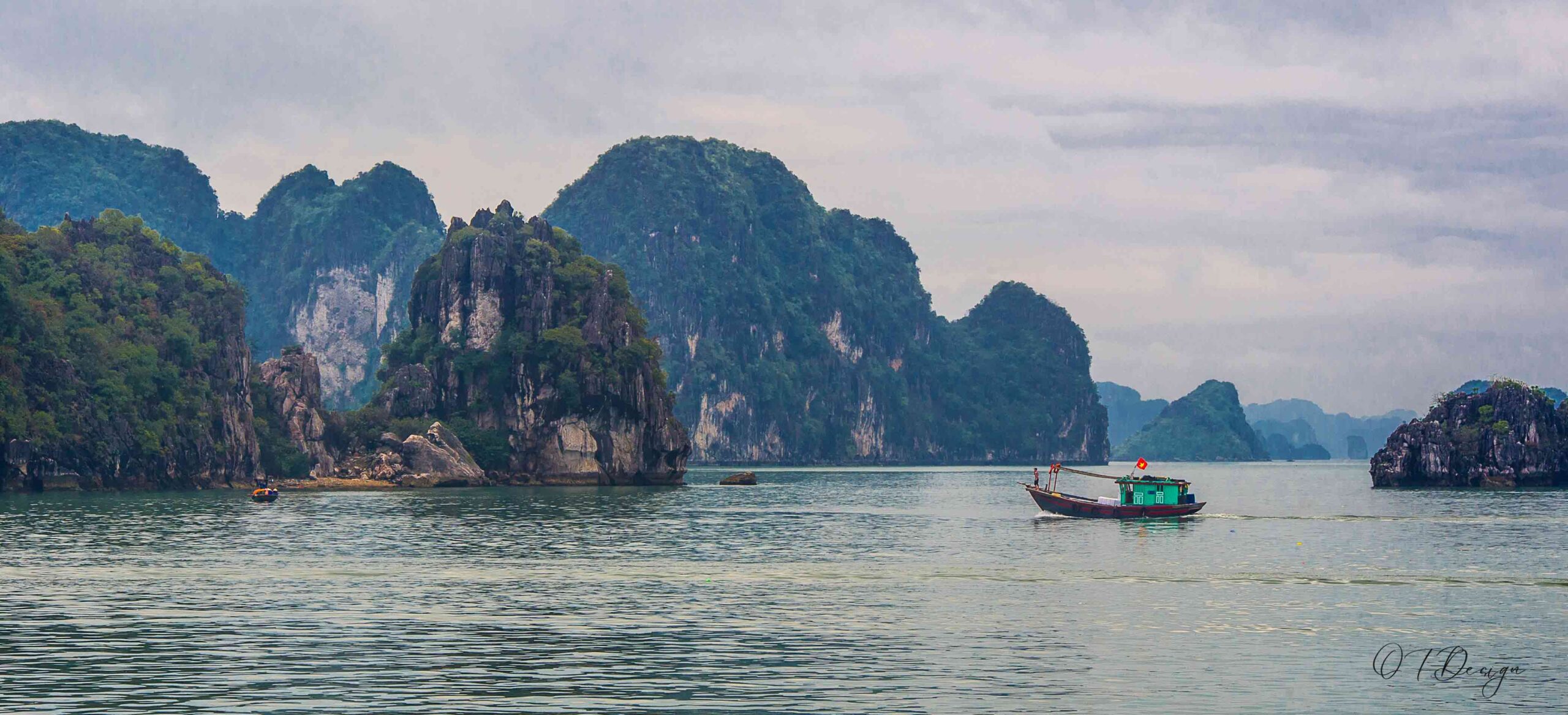 A boat with the Vietnamese flag crossing the Ha Long Bay in Vietnam