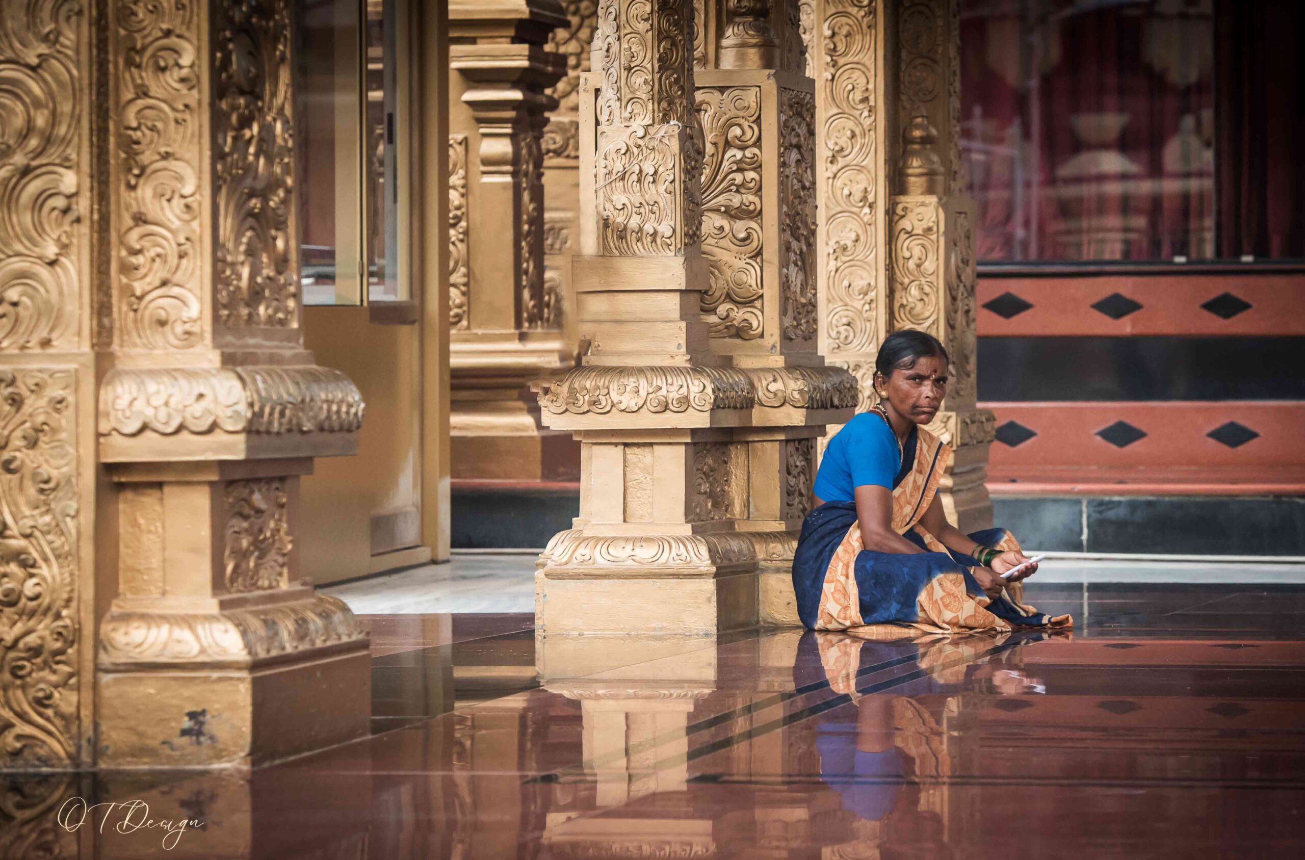Lady praying on the floor of a temple in Mangalore, India