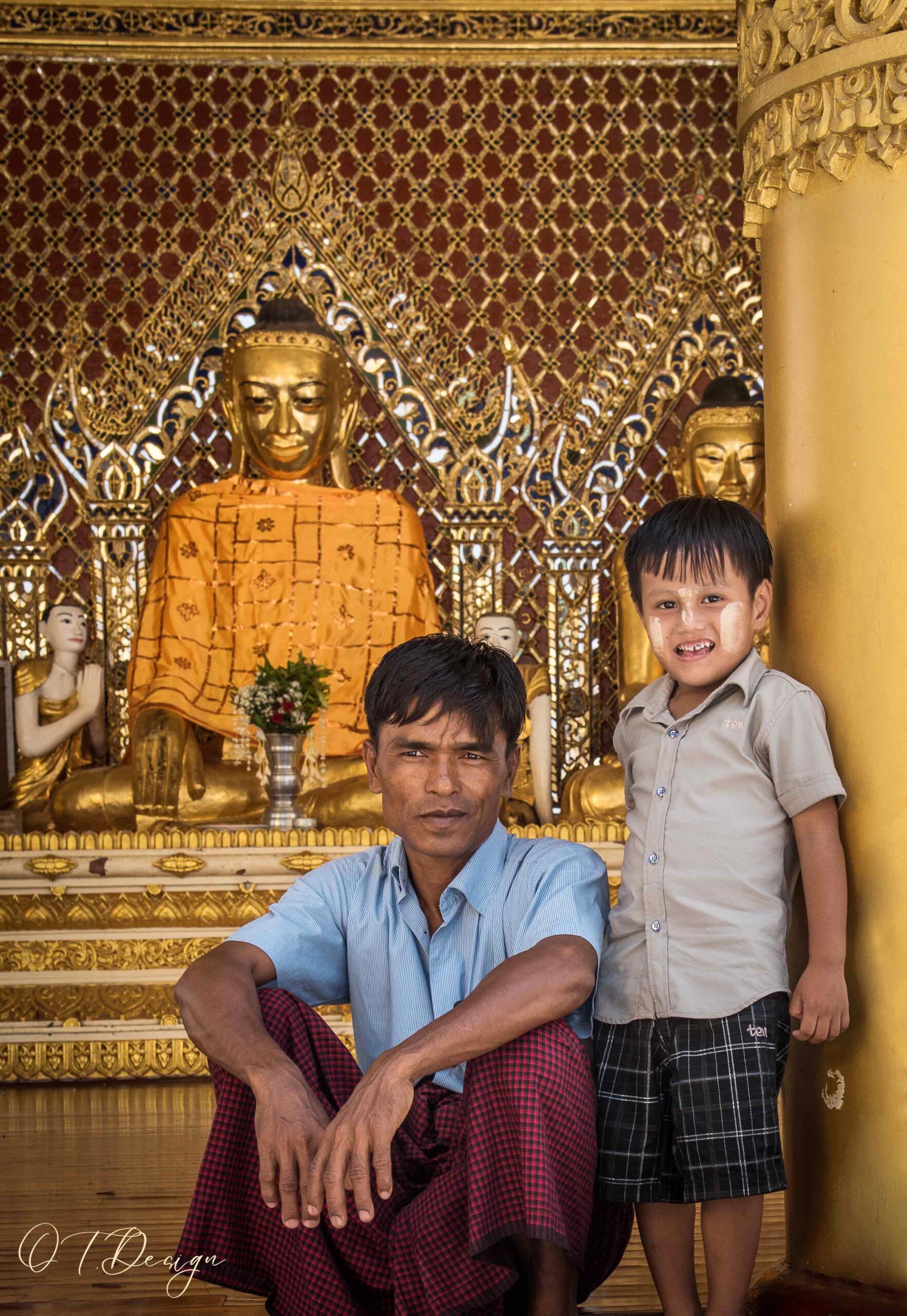 Father and his son in a sacred temple in Yangon, Myanmar 