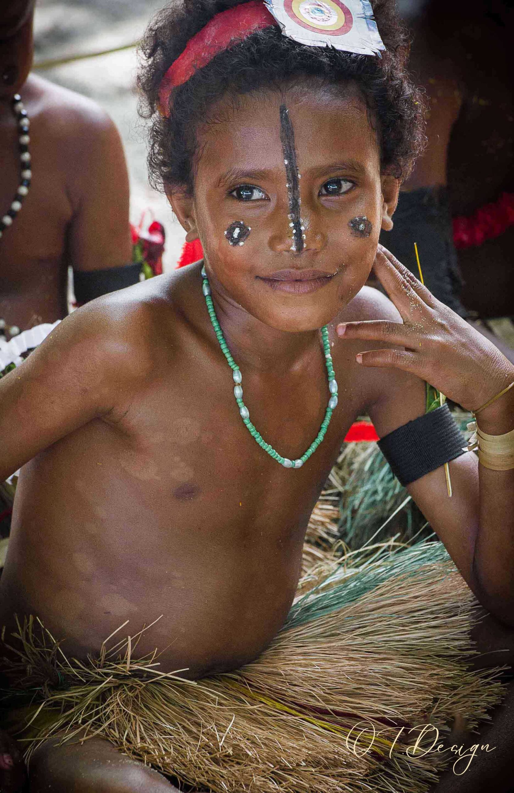 A beautiful expressive young girl painted on her face in Kitava Island, Papua New Guinea