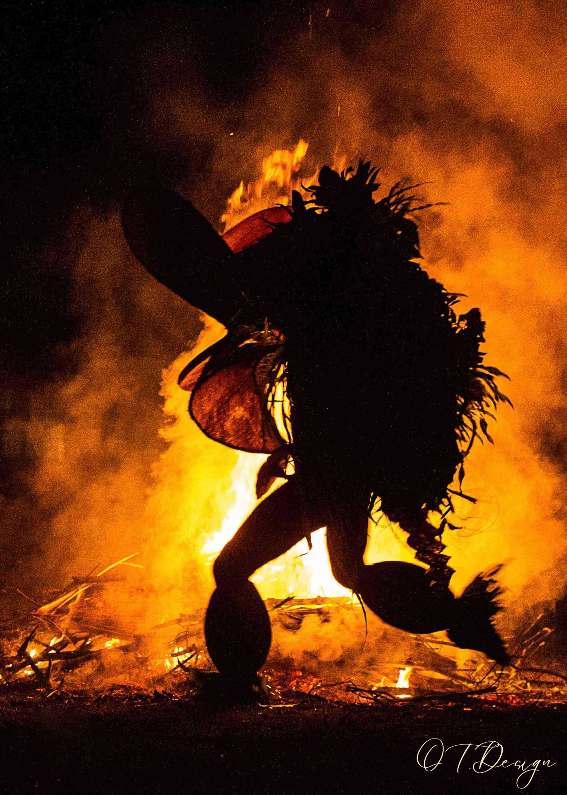 A young men crossing through fire in the "Sacred Baining Fire Dance" in Rabaul, Papua New Guinea