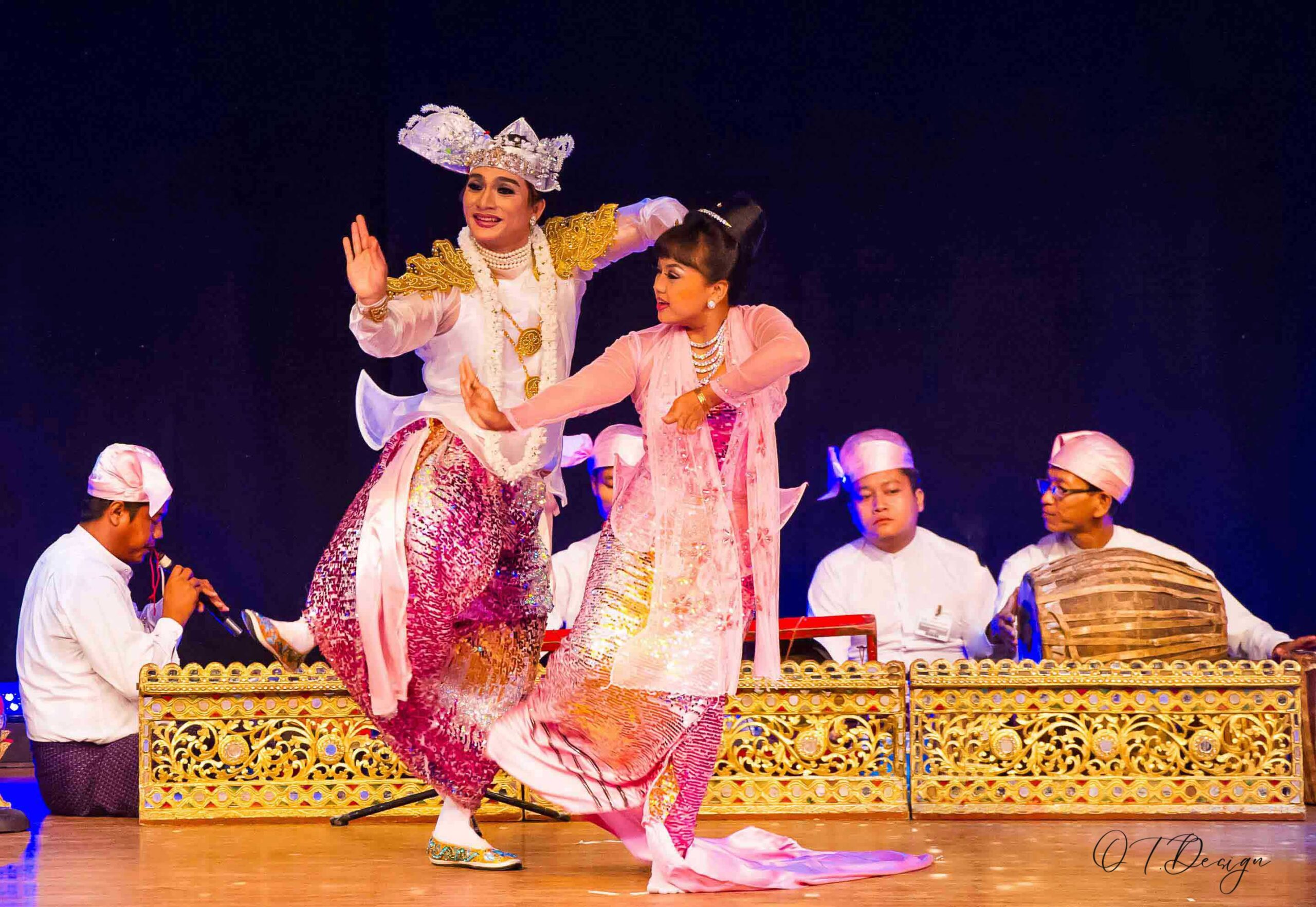 Two dancers performing on stage with a band a traditional dance of Myanmar in Yangon
