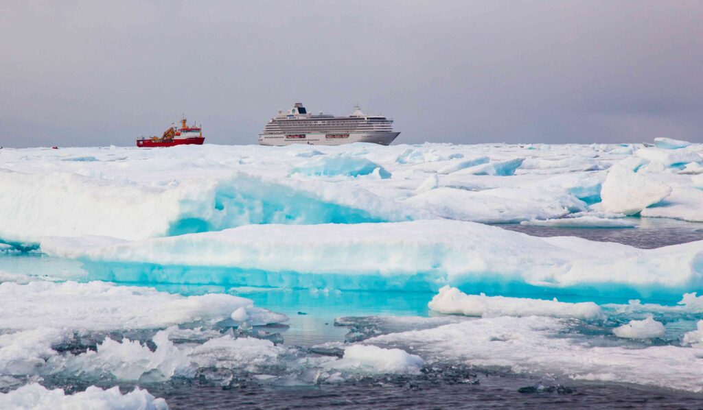 Captivating scene of Crystal Serenity navigating alongside Shackleton icebreaker through the icy expanse of the Northwest Passage, symbolizing the grandeur and resilience of Arctic exploration.
