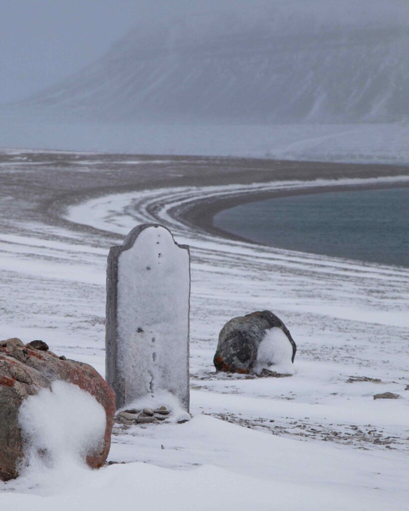 Silent testimony to Arctic exploration: A weathered gravestone on Beechey Island, standing as a memorial to the adventurers who sought the Northwest Passage.