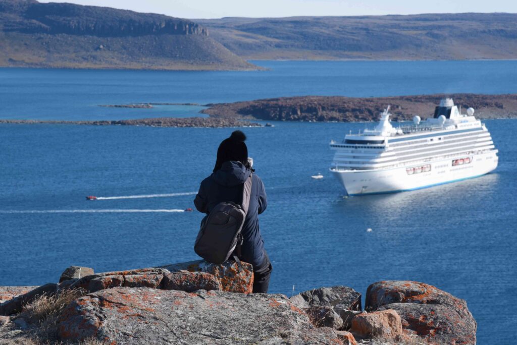 A unique perspective as I photograph Crystal Serenity from atop a cliff in Ulukhaktok, offering a breathtaking view of the ship against the Nortthwest Territories.